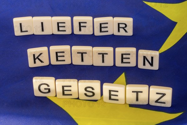 Letters on an EU flag show the word SUPPLY CHAIN LAW
