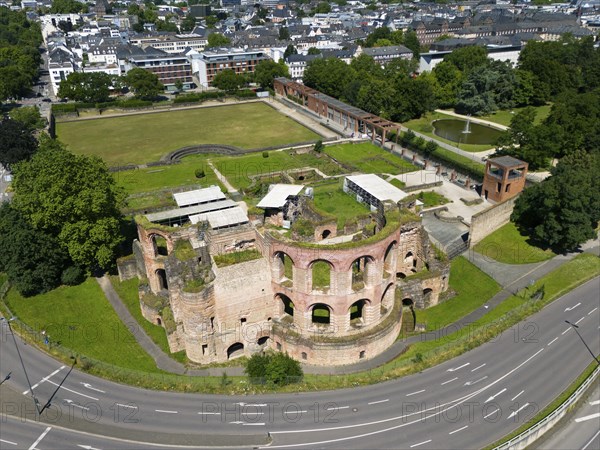 Aerial view of historical ruins in a city, surrounded by streets and a green park, aerial view,
