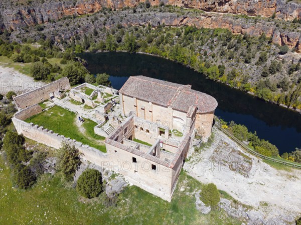 Historic ruin in a rocky landscape with river and lush vegetation, bird's eye view, aerial view,