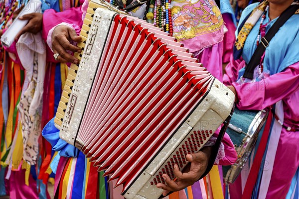 Accordionist playing his instrument during a religious festival in the streets of Belo Horizonte,