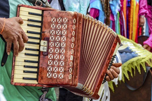 Accordionist playing during an important and traditional religious festival in the streets of Belo