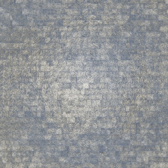 A textured abstract pattern featuring a mosaic of small squares with blue and silver metallic tones