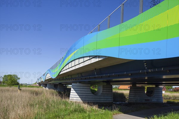 Colourfully painted motorway bridge with noise barrier over the river Este, Buxtehude, Altes Land,
