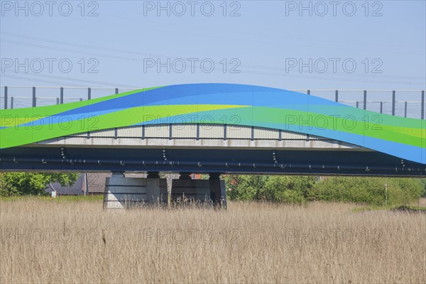 Colourfully painted motorway bridge with noise barrier over the river Este, Buxtehude, Altes Land,