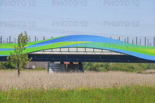 Colourfully painted motorway bridge with noise barrier over the river Este, Buxtehude, Altes Land,