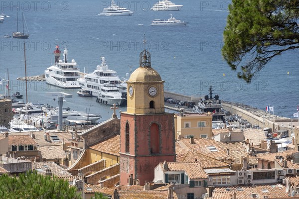 View over the roofs of Saint Tropez with the church Notre-Dame de l'Assomption, behind it the bay