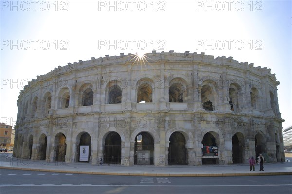 Roman amphitheatre and landmark backlit, Nîmes, Gard, Provence, France, Europe