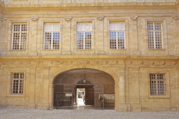 House facade with metal gate and window in the inner courtyard of the town hall, decorations,
