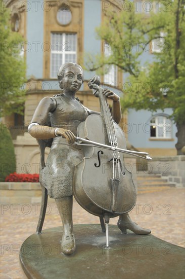 Musicians' fountain with cello player by Bonifatius Stirnberg 1989 in front of the blue town hall,