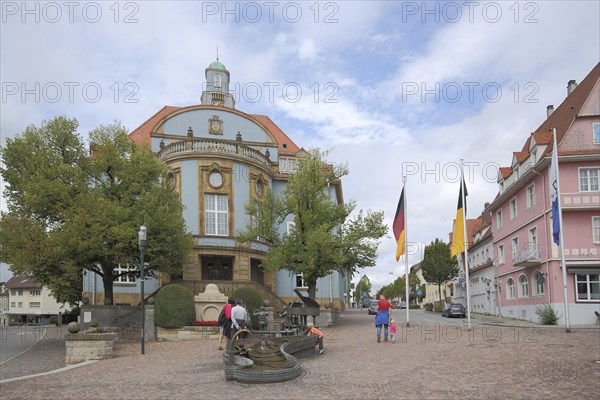 Blue town hall in Art Nouveau style with musicians' fountain, people, Donaueschingen, Southern