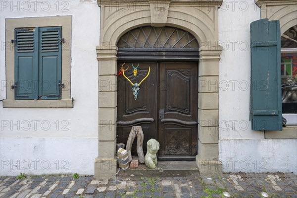 Art objects in front of a historic entrance gate, Mainbernheim, Lower Franconia, Bavaria, Germany,