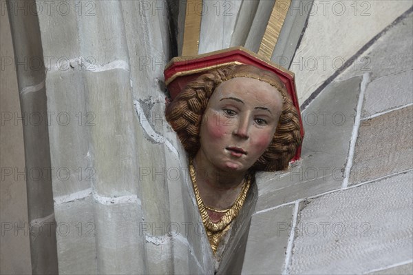 Young woman's head console stone in Heilig Kreuz Minster, Rottweil, Baden-Württemberg, Germany,