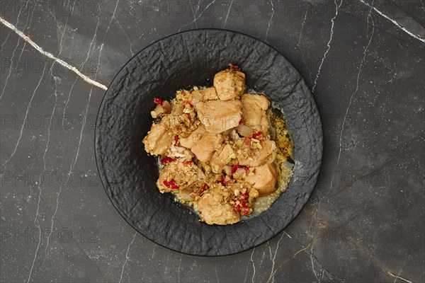 Overhead view of portion of chicken fillet ragout with walnuts