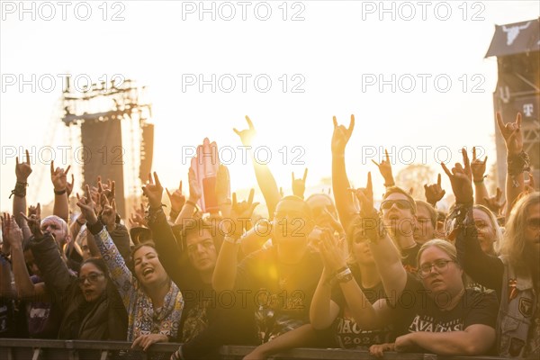 Festival-goers in the front row give the devil's salute at the Wacken Open Air in Wacken. The