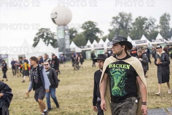A festival visitor with Wacken shirt and cowboy hat at the Wacken Open Air in Wacken. The