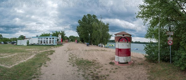 Old round red and white striped changing room from GDR times in the shape of a lighthouse on the