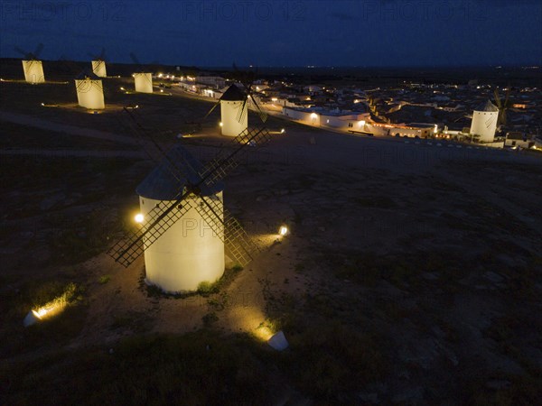 Illuminated windmills in a village at night, aerial view, windmills, Campo de Criptana, Ciudad Real