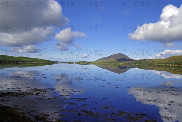Calm lake with cloud reflections and mountains in the background, Letterfrack, Connemara National