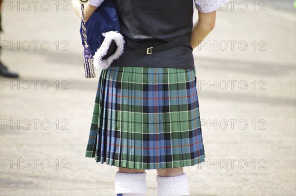 A person in a traditional Scottish kilt from behind, tradition, history, Scotland, Great Britain