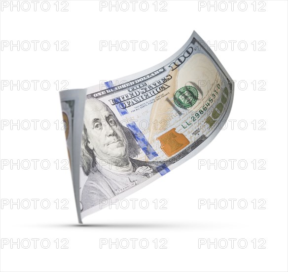 One hundred dollar bill floating down to surface with drop shadow isolated on a white background