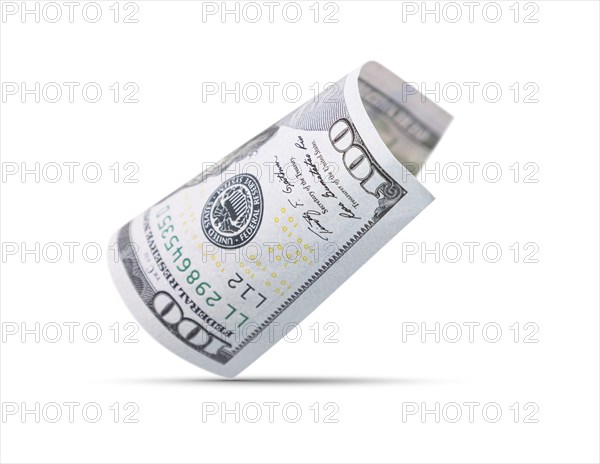 One hundred dollar bill floating down to surface with drop shadow isolated on a white background