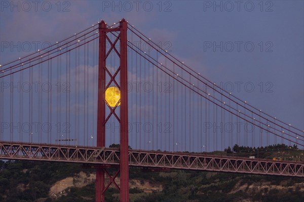 Full Moon and 25 April Bridge. Lisbon, Portugal, Europe