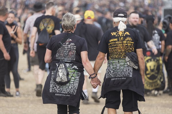 Elderly couple with Wacken shirts at the Wacken Open Air in Wacken. The traditional metal festival