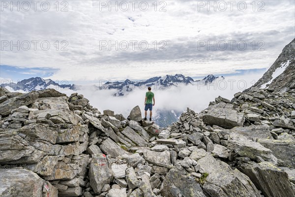 Mountaineer in a rocky saddle, Lapenscharte with view of mountain peaks, Berliner Höhenweg,