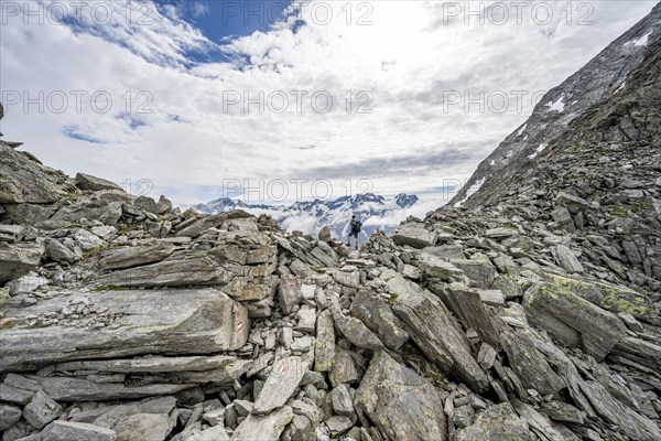 Mountaineer in a rocky saddle, Lapenscharte with view of mountain peaks, Berliner Höhenweg,
