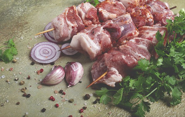 Raw pork meat, on wooden skewers, pickled kebab, with spices and herbs, on the table, top view, no