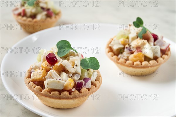 Canapes with salad, corn with crab sticks, appetizer, portioned, close-up, no people