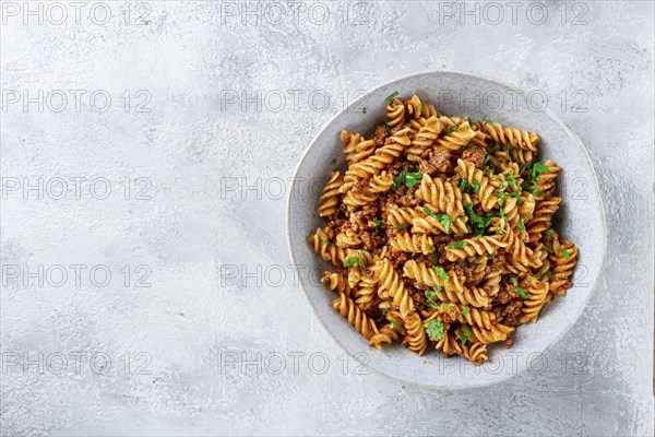 Pasta in navy, pasta with minced meat, gray background, homemade, fusilli pasta, no people