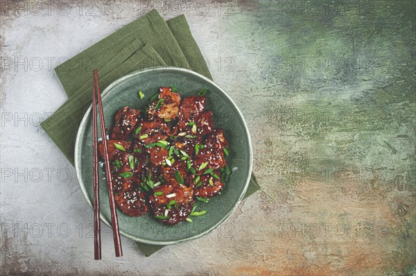 Yakitori chicken kebab, on a plate, with green onions and sesame seeds, top view, no people