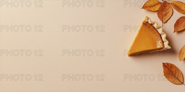 Banner with single slice of pumpkin pie with autumn leaves on beige background with copy space.