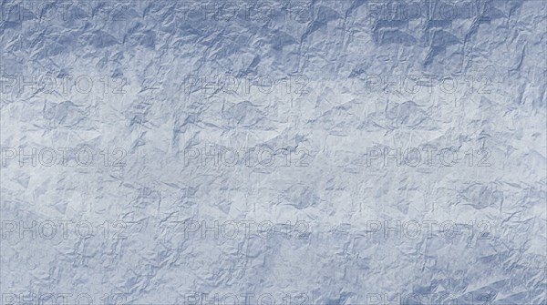 Crumpled paper with textured surface in varying blue tones creating an abstract pattern