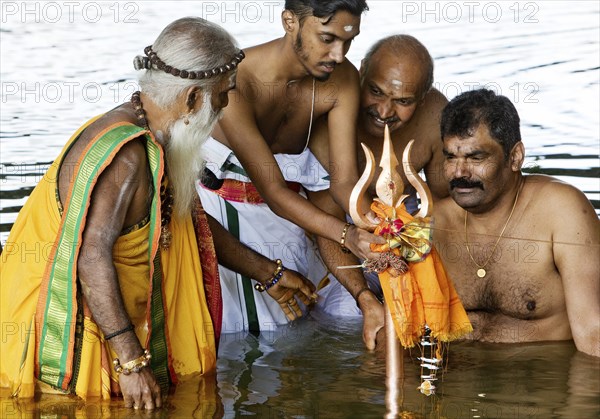 Head priest Siva Sri Arumugam Paskarakurukkal in the Datteln-Hamm canal during ritual purification,