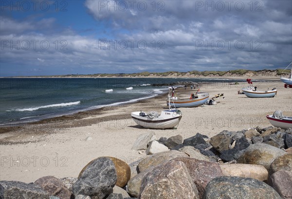 The beach at Norre Vorupor with rocks in the foreground in North Jutland, Denmark, Europe