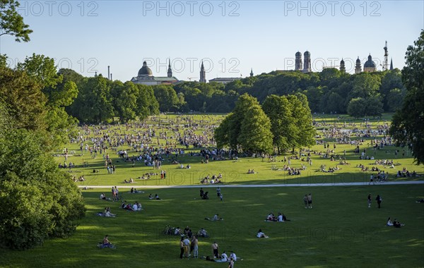 View from the Monopteros in the English Garden, meadows full of visitors on a summer day, Munich