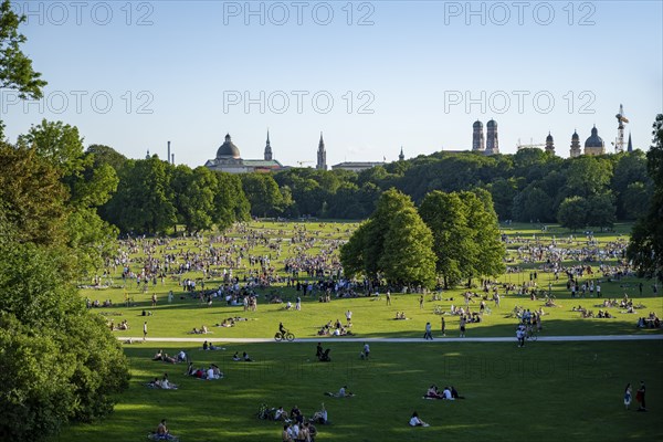 View from the Monopteros in the English Garden, meadows full of visitors on a summer day, Munich
