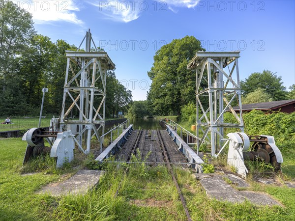 Landing stage of the historic railway ferry with overgrown old rails on the banks of the Havel in