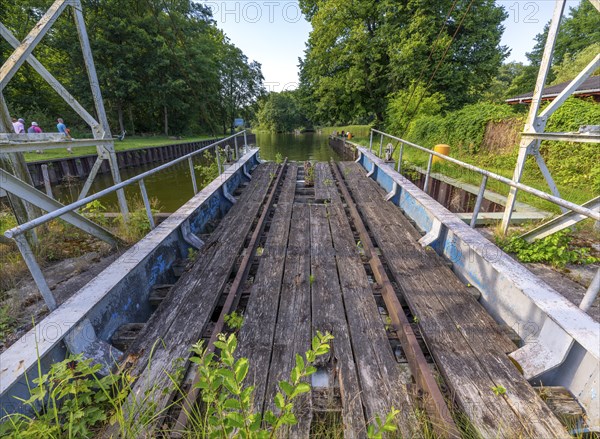 Landing stage of the historic railway ferry with overgrown old rails on the banks of the Havel in