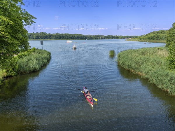 Paddle boat, paddler, and small motorboat on the Havel between Baalensee and Schwedtsee (behind),