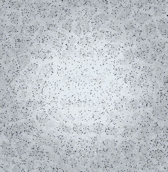 Grey speckled textured surface appearing like concrete with a rough abstract pattern