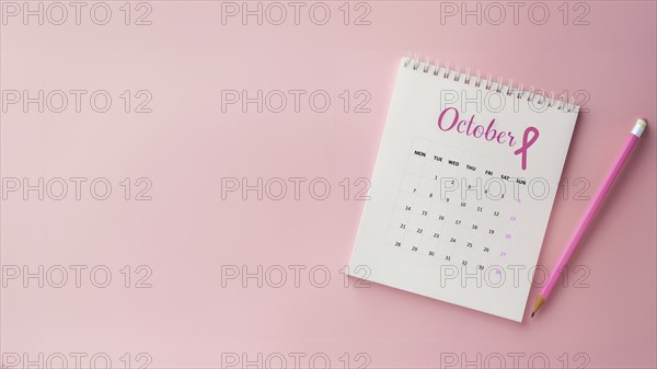 October calendar with a breast cancer awareness pink ribbon and a pencil with copyspace, AI