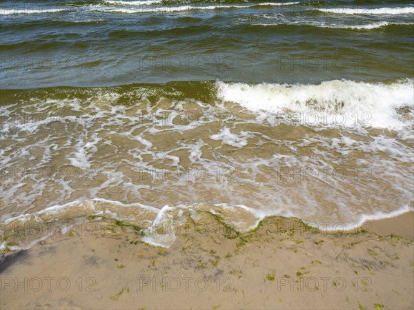 Water flowing onto the sandy beach on the island of Usedom on the Baltic Sea, Zempin,