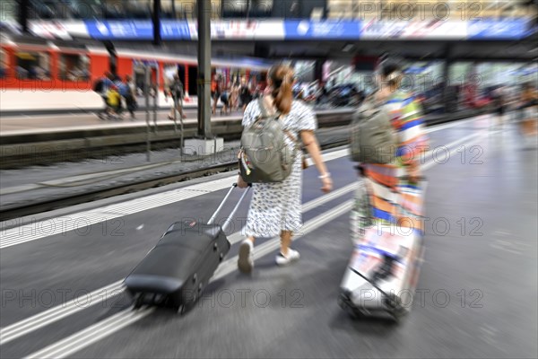 Wipe-off picture SBB railway station passers-by with trolley case