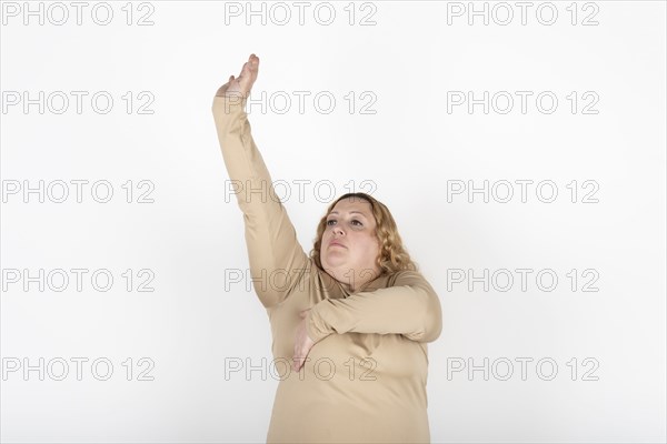 Plus size woman doing a Breast Self-Exam (BSE)
