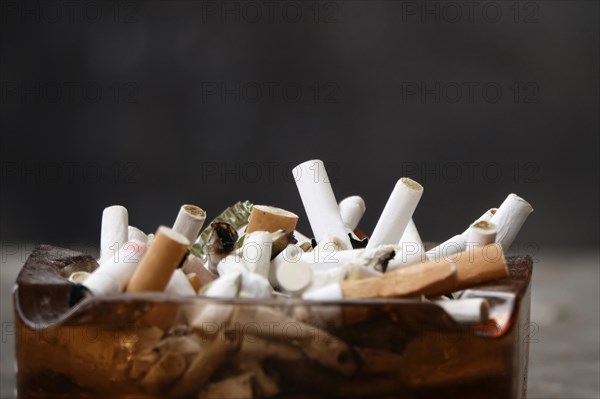 Ashtray with cigarette butts, Germany, Europe