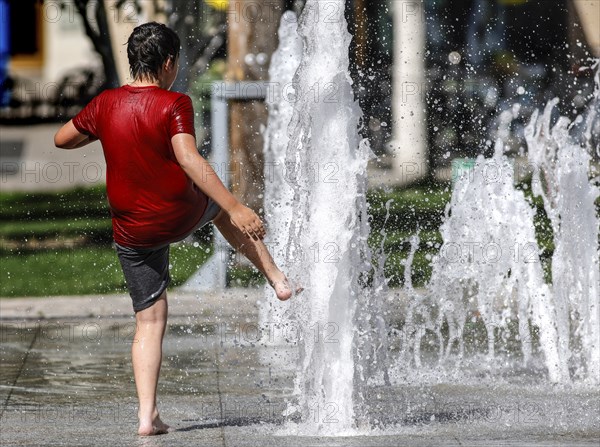 A boy cools off at a fountain, Berlin, 30.07.2024., Berlin, Berlin, Germany, Europe