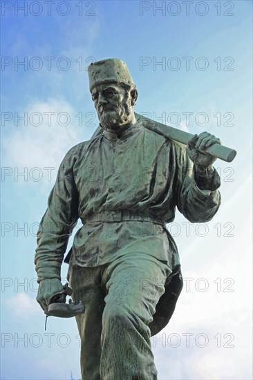 Miner Henner with pickaxe by Friedrich Reusch 1902, symbol for miner in mining, mine, worker,